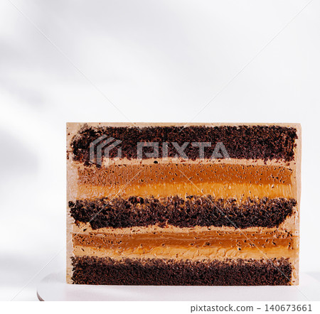 Chocolate caramel layer cake showing rich texture Chocolate caramel layer cake showing rich texture 140673661