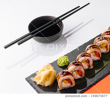 Sushi rolls with eel sauce, wasabi, ginger, and soy sauce Sushi rolls with eel sauce, wasabi, ginger, and soy sauce 140673677