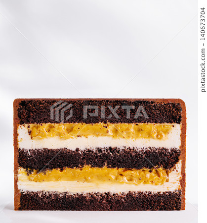 Chocolate cake cross-section revealing layered caramel and cream fillings 140673704