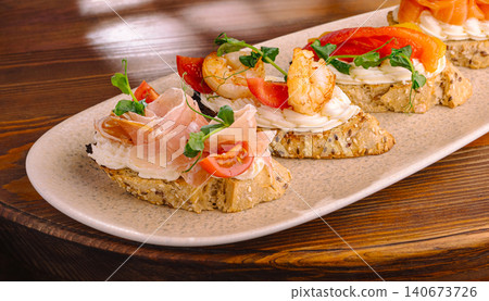Gourmet appetizers with prosciutto shrimp and smoked salmon Gourmet appetizers with prosciutto shrimp and smoked salmon 140673726