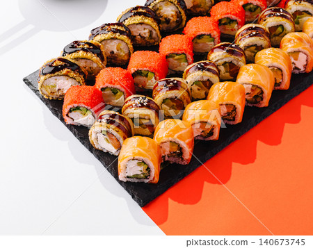Sushi rolls set on black slate platter Sushi rolls set on black slate platter 140673745
