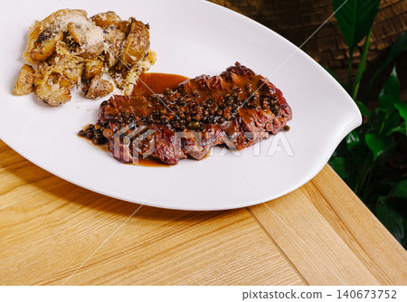Steak au poivre with crushed potatoes and parmesan Steak au poivre with crushed potatoes and parmesan 140673752