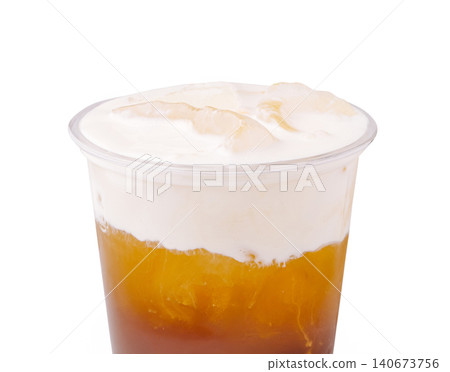 Iced tea with cheese cream top in plastic cup Iced tea with cheese cream top in plastic cup 140673756