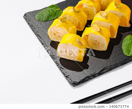 Banana sushi dessert rolls with pistachio and mint 140673774