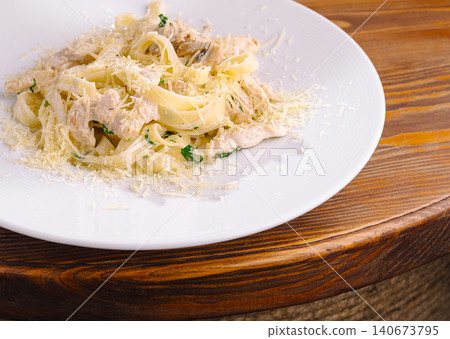 Chicken fettuccine alfredo with parmesan cheese on plate Chicken fettuccine alfredo with parmesan cheese on plate 140673795