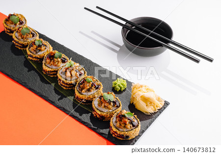 Fried sushi rolls set with soy sauce and chopsticks Fried sushi rolls set with soy sauce and chopsticks 140673812