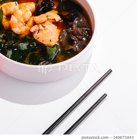 Asian style seafood soup with salmon and shrimp Asian style seafood soup with salmon and shrimp 140673843