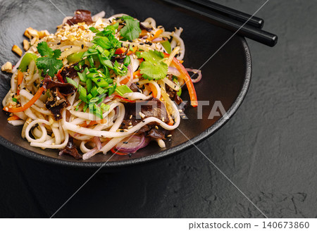 Asian udon noodle salad with vegetables and peanuts Asian udon noodle salad with vegetables and peanuts 140673860