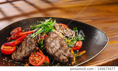 Grilled beef steak salad with fresh vegetables and sesame seeds 140673877