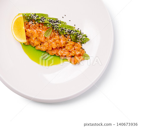 Salmon tartare with avocado slices and sesame oil dressing Salmon tartare with avocado slices and sesame oil dressing 140673936