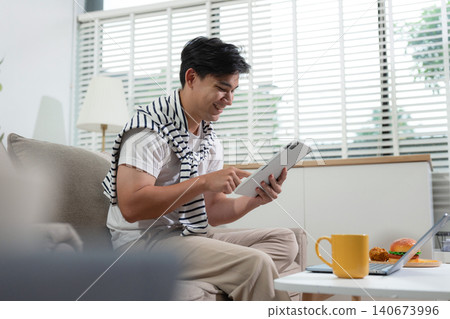 Male working online from home, small business lifestyle Male working online from home, small business lifestyle 140673996