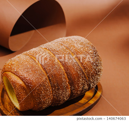 Trdelnik chimney cake with sugar on wooden tray Trdelnik chimney cake with sugar on wooden tray 140674063