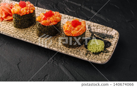 Gunkan sushi with salmon and red caviar on plate 140674066