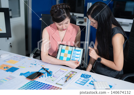 Creative team brainstorming digital branding strategy, designers discussing UX and content production in office. 140674132