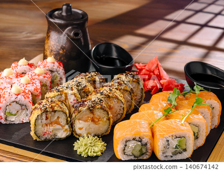 Assortment of sushi rolls with salmon, tempura, and tobiko Assortment of sushi rolls with salmon, tempura, and tobiko 140674142