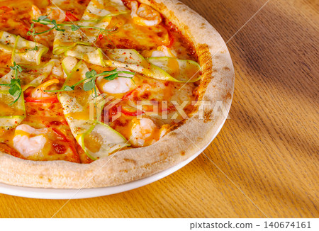 Shrimp and zucchini pizza on a wooden table 140674161