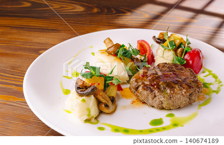 Gourmet beef meal with mashed potatoes and vegetables 140674189