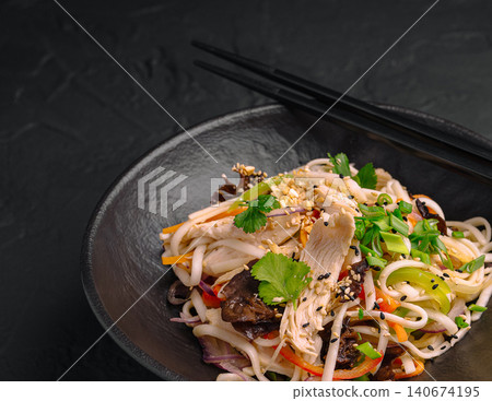 Asian udon noodle salad with chicken and vegetables Asian udon noodle salad with chicken and vegetables 140674195