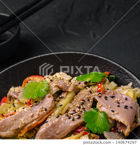 Asian beef salad with vegetables, sesame and cilantro Asian beef salad with vegetables, sesame and cilantro 140674297