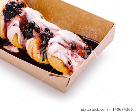 Syirniki cottage cheese pancakes with berry sauce in takeaway box Syirniki cottage cheese pancakes with berry sauce in takeaway box 140674306