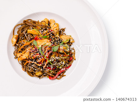 Soba noodles chicken stir fry dish with sesame seeds Soba noodles chicken stir fry dish with sesame seeds 140674313