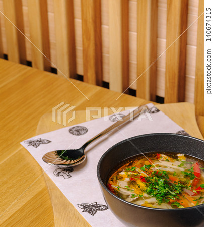 Chicken noodle soup with vegetables and herbs 140674315