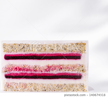 Layering poppy seed cake with berry filling showing texture Layering poppy seed cake with berry filling showing texture 140674318