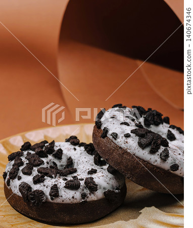 Cookies and cream donuts with chocolate sprinkles on plate Cookies and cream donuts with chocolate sprinkles on plate 140674346