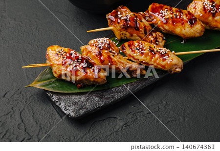 Grilled chicken wings yakitori with teriyaki glaze Grilled chicken wings yakitori with teriyaki glaze 140674361