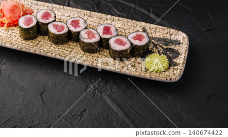 Tuna maki sushi rolls on plate with wasabi and ginger 140674422