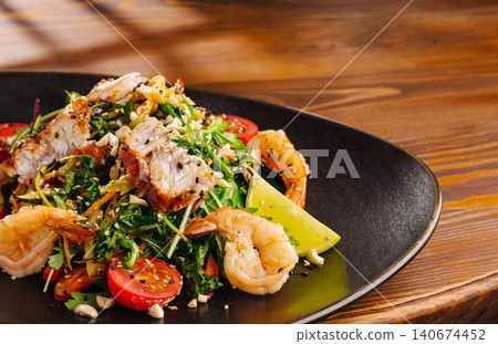 Gourmet seafood and chicken salad on wooden table Gourmet seafood and chicken salad on wooden table 140674452