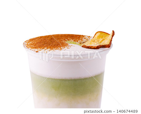 Layered matcha foam latte with cinnamon and apple chip Layered matcha foam latte with cinnamon and apple chip 140674489