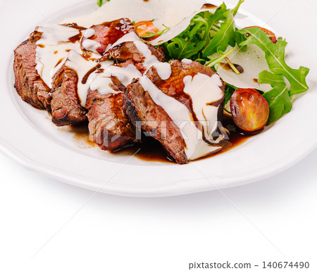 Sliced beef fillet with creamy sauce and arugula salad Sliced beef fillet with creamy sauce and arugula salad 140674490