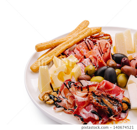 Antipasto platter with cured meat, cheeses, and olives Antipasto platter with cured meat, cheeses, and olives 140674521