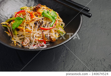 Glass noodle funchose salad with vegetables and chopsticks 140674524