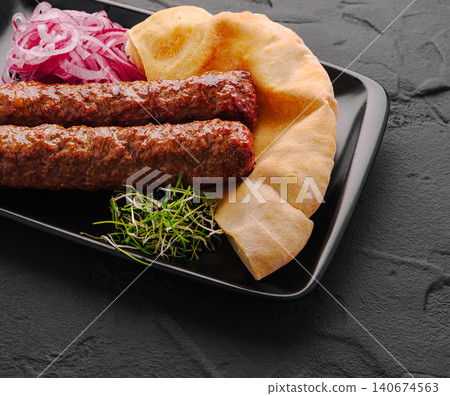 Lulya kebab with pita bread and pickled onions Lulya kebab with pita bread and pickled onions 140674563