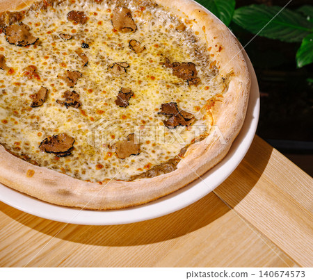 Gourmet truffle pizza with cheese on a white plate 140674573