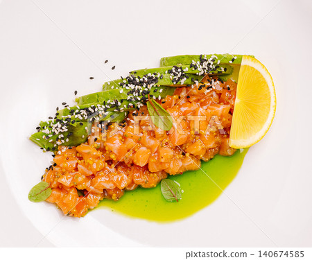 Salmon tartare with avocado, lemon, and sesame seeds Salmon tartare with avocado, lemon, and sesame seeds 140674585