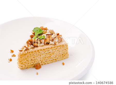 Slice of sponge cake with almonds and mint 140674586