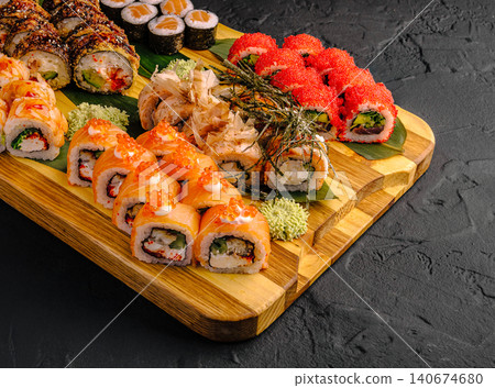 Assorted sushi and maki rolls on a wooden board Assorted sushi and maki rolls on a wooden board 140674680