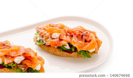 Smoked salmon bruschetta with cream cheese and arugula Smoked salmon bruschetta with cream cheese and arugula 140674698