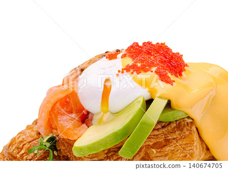 Croissant with poached egg, salmon, avocado, hollandaise, caviar Croissant with poached egg, salmon, avocado, hollandaise, caviar 140674705