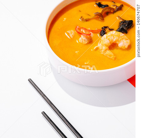 Spicy tom yum soup with shrimp and chopsticks Spicy tom yum soup with shrimp and chopsticks 140674707