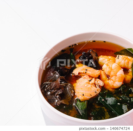 Seafood miso soup with salmon, shrimp, mushrooms, seaweed 140674724