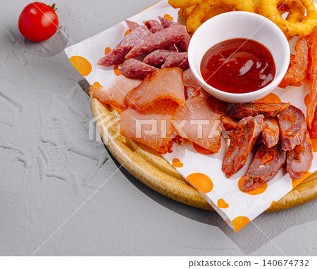 Assorted meat platter with sauce and onion rings Assorted meat platter with sauce and onion rings 140674732