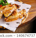 Golden brown roasted chicken with fresh salad on wooden platter 140674737