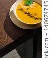 Pumpkin shrimp soup with seeds on wooden table 140674745