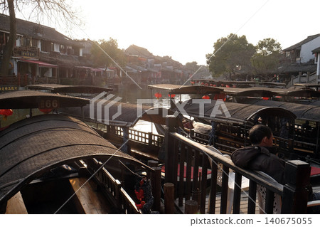 Tourist boats on the water canals of Xitang Town in Zhejiang Province, China 140675055