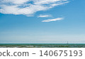 calm sea with a yacht sailing on the horizon, a summer vacation concept and an invitation to a tour or yacht trip, copy space for text 140675193