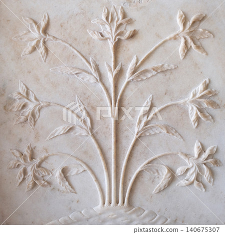 Mughal stone art on the facade of the Taj Mahal (Crown of Palaces), an ivory-white marble mausoleum in Agra, Uttar Pradesh, India Mughal stone art on the facade of the Taj Mahal (Crown of Palaces), an ivory-white marble mausoleum in Agra, Uttar Pradesh, India 140675307